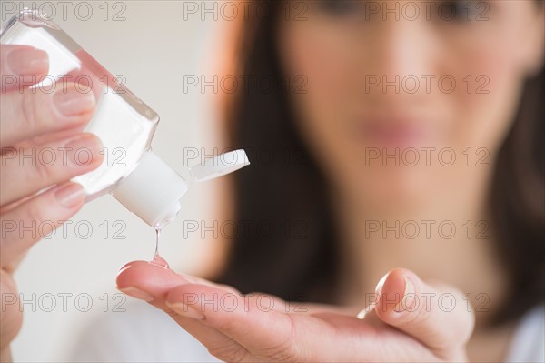 Woman using hand sanitizer.