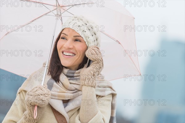 Woman with umbrella using phone.