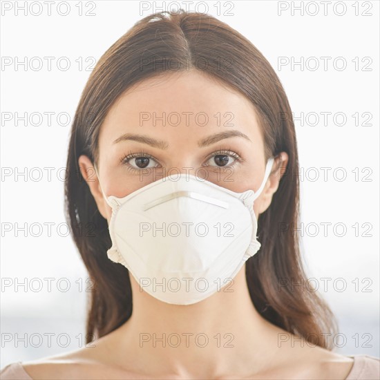 Studio portrait of woman wearing flu mask.