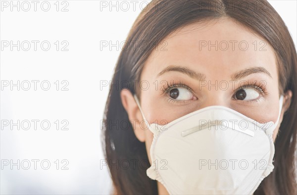 Studio portrait of woman wearing flu mask.