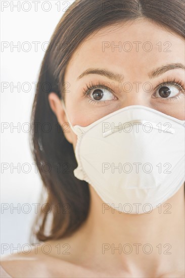 Studio portrait of woman wearing flu mask.