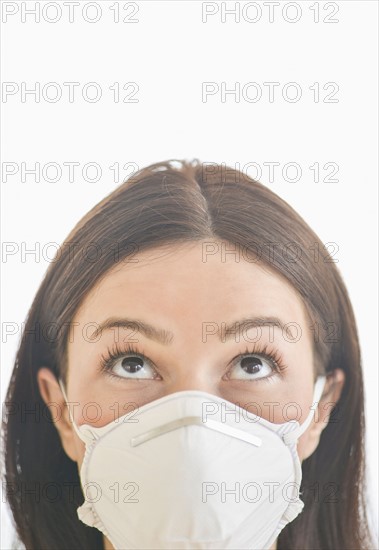 Studio portrait of woman wearing flu mask.