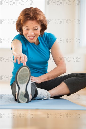 Senior woman stretching.