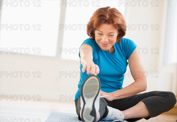 Senior woman stretching.