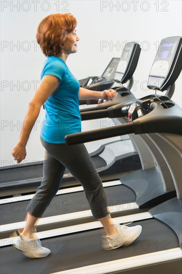 Senior woman on treadmill.