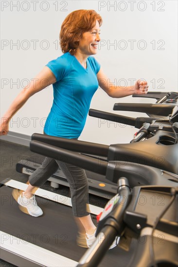 Senior woman on treadmill.