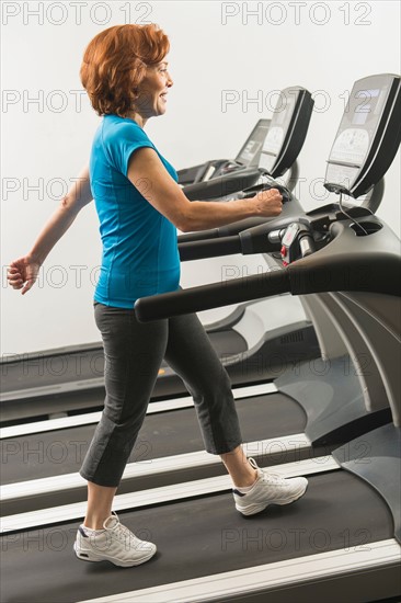 Senior woman on treadmill.