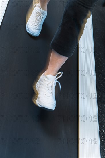 Low section of woman on treadmill.