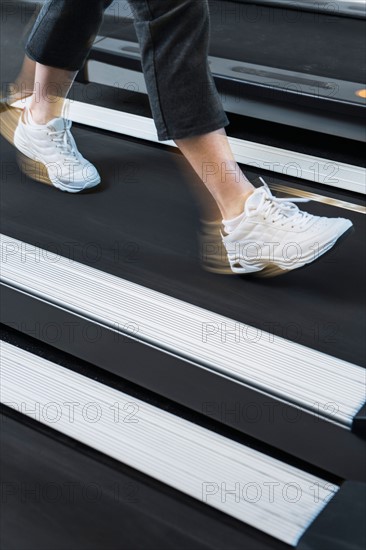 Low section of woman on treadmill.