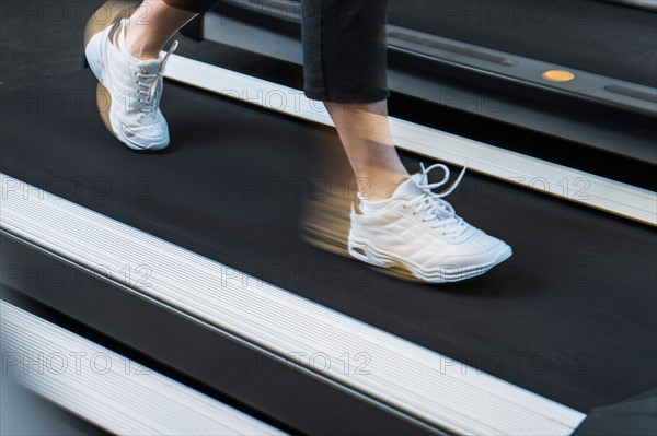 Low section of woman on treadmill.