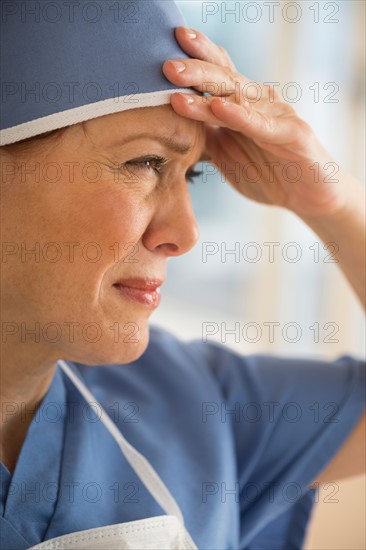 Female surgeon suffering headache.