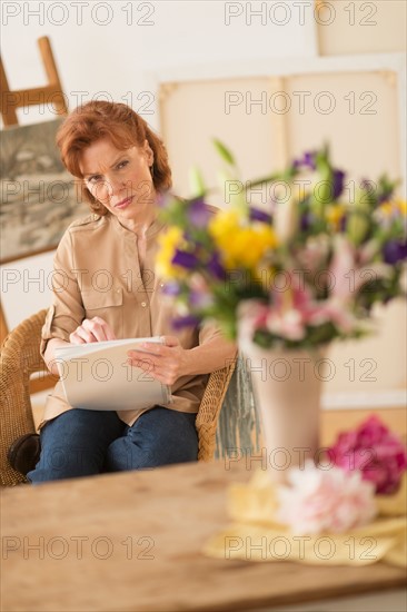 Woman sketching flowers.