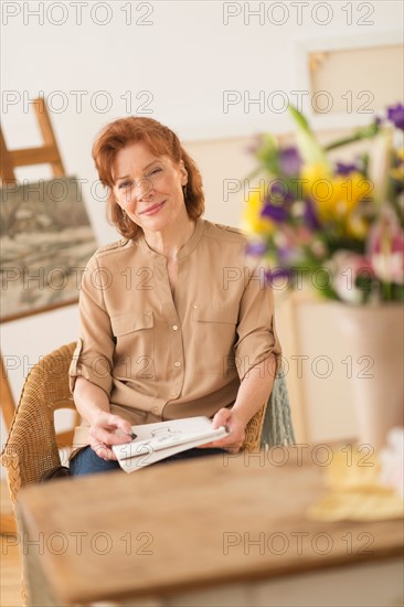 Portrait of female artist in studio.