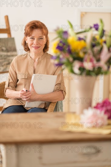 Portrait of female artist in studio.