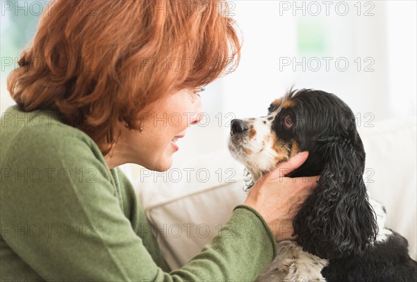 Woman stroking dog.