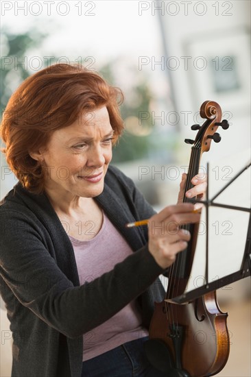 Senior woman composing music.