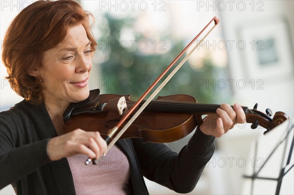 Senior woman playing violin.