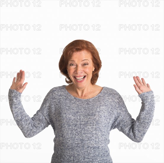 Studio shot of senior woman smiling.