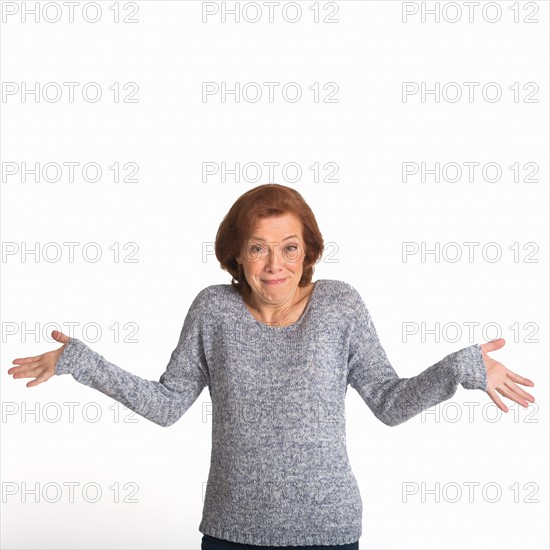 Studio shot of senior woman smiling.