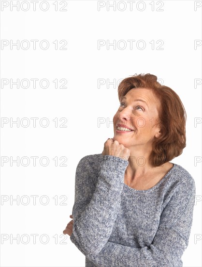 Studio shot of senior woman smiling.