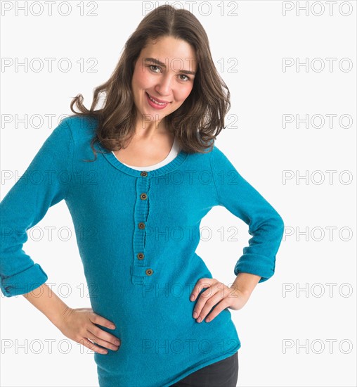 Studio portrait of young woman smiling.