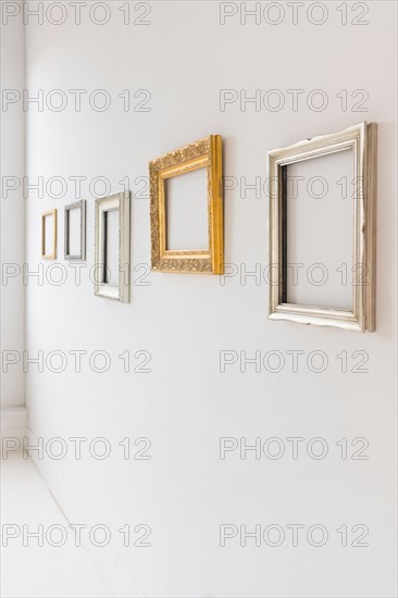 Empty picture frames in art gallery.