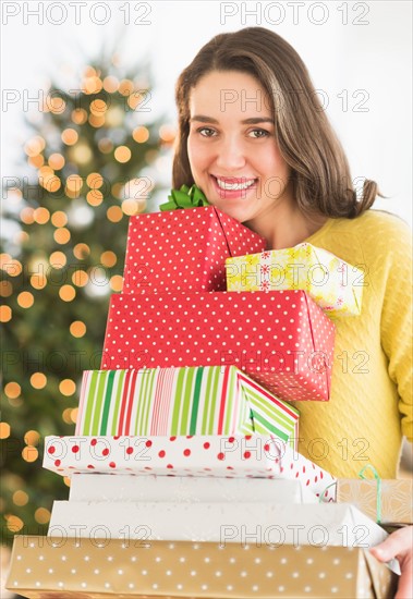 Woman holding christmas gifts.