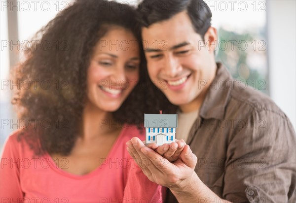 Smiling couple with model home.