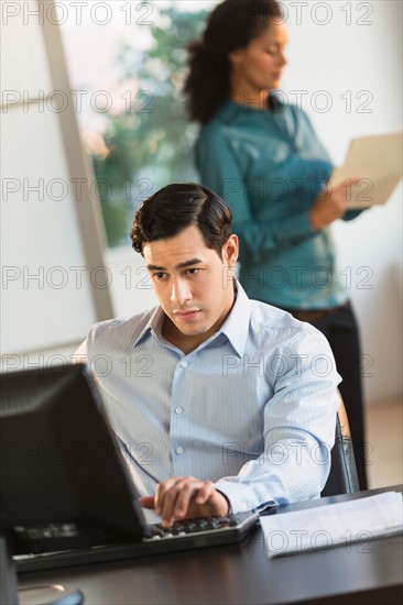 Man and woman working in office.