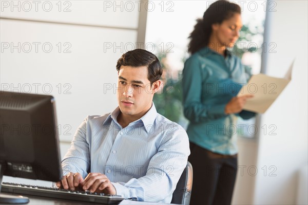 Man and woman working in office.