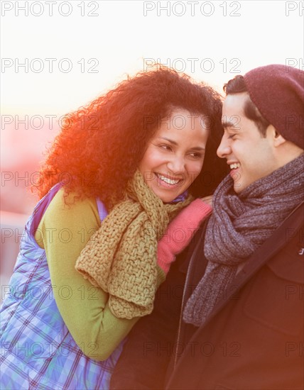 Portrait of happy couple embracing at sunset.