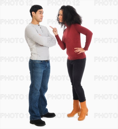 Studio shot of young couple arguing.