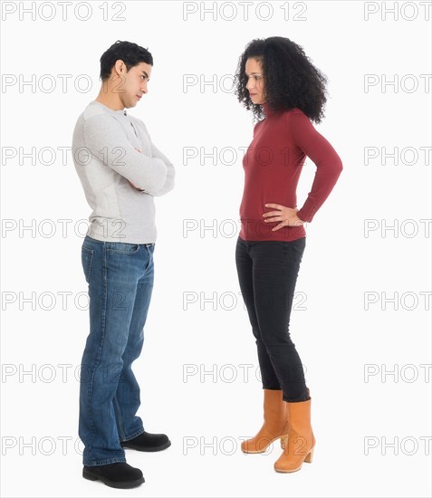 Studio shot of young couple arguing.