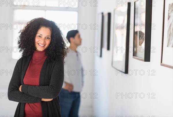 Visitors looking at artworks in gallery.