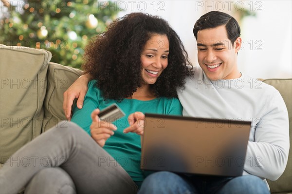 Couple using laptop for online shopping.