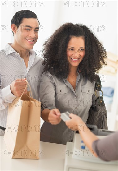 Couple shopping in clothes shop.