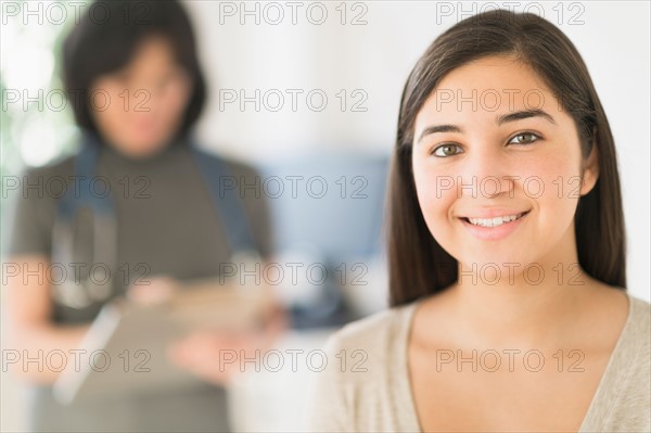 Teenage girl (16-17) in doctor's office.