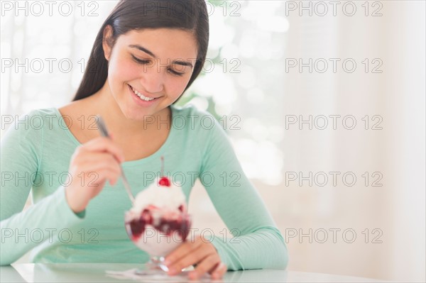 Teenage girl (16-17) eating ice-cream.