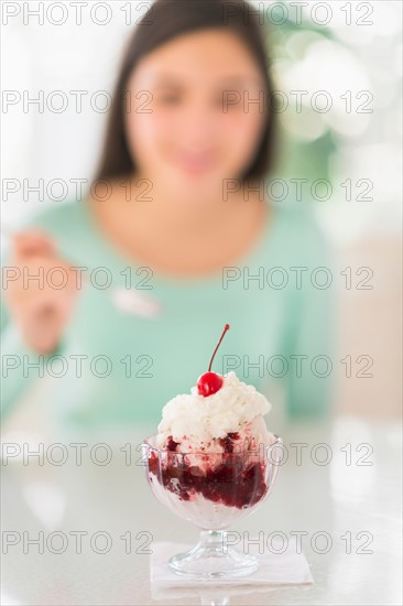 Teenage girl (16-17) eating ice-cream.