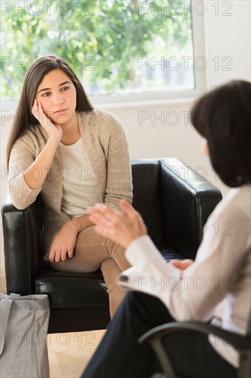 Teenage girl (16-17) talking to therapist.