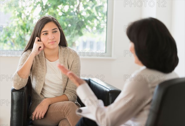 Teenage girl (16-17) talking to therapist.