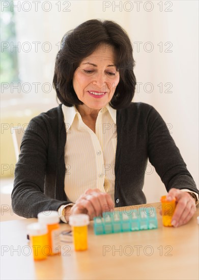 Senior woman dozing pills.