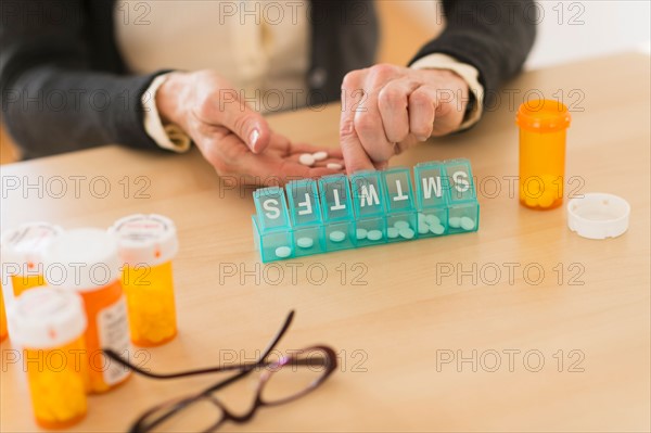 Senior woman dozing pills.