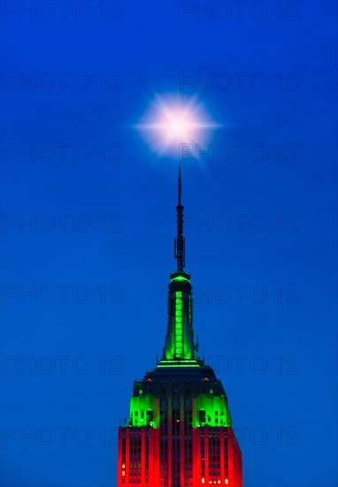 Empire State Building illuminated in red and green.