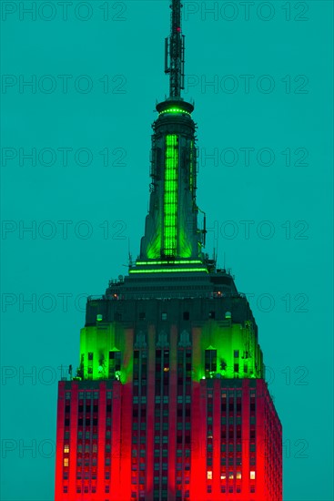 Empire State Building illuminated in red and green.