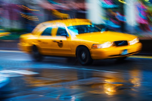 Yellow cab in blurred motion.