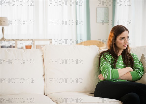 Young woman sitting on couch