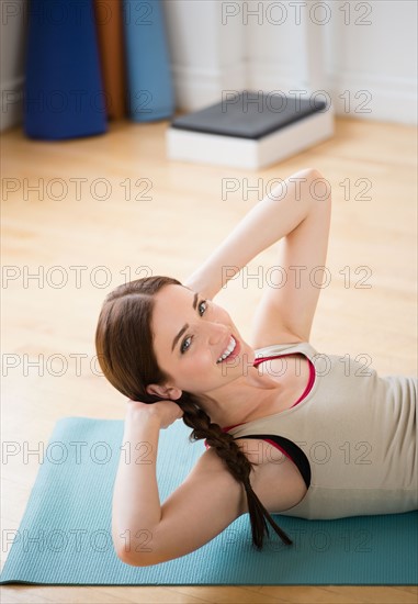 Young woman exercising at home