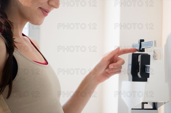 Young woman on scales