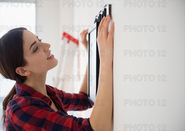 Young woman redecorating room